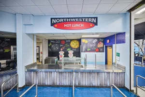 A branded serving line station in a school cafeteria to improve school lunch participation.