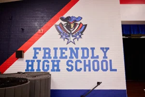 Showcasing a school mural with the Friendly High School mascot and school name and blue and red paint additions that can help improve your school cafeteria.