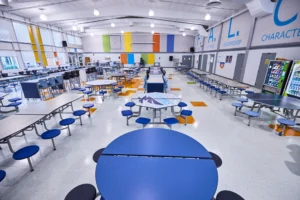 A school cafeteria with painted walls and cafeteria furniture.